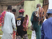 Prayer beads sellers are walking away as Muslim faithful are praying to mark the Eid-El-Kabir festival in Ikeja, Lagos, Nigeria, on Sunday,...