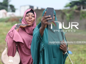 Female Muslims are taking a selfie with excitement as Muslim faithful are praying to mark the Eid-El-Kabir festival in Ikeja, Lagos, Nigeria...