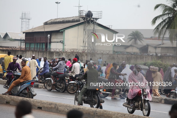 Commercial motorcyclists are awaiting passengers as Muslim faithful are praying to mark the Eid-El-Kabir festival in Ikeja, Lagos, Nigeria,...