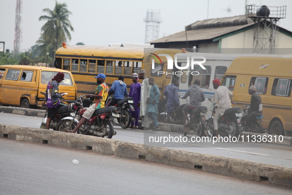 Commercial motorcyclists are awaiting passengers as Muslim faithful are praying to mark the Eid-El-Kabir festival in Ikeja, Lagos, Nigeria,...