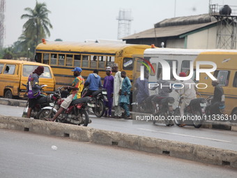 Commercial motorcyclists are awaiting passengers as Muslim faithful are praying to mark the Eid-El-Kabir festival in Ikeja, Lagos, Nigeria,...