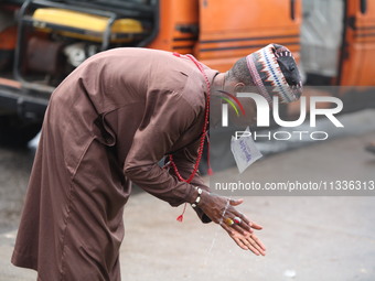 A Muslim faithful is washing his hands as Muslim faithful are praying to mark the Eid-El-Kabir festival in Ikeja, Lagos, Nigeria, on Sunday,...