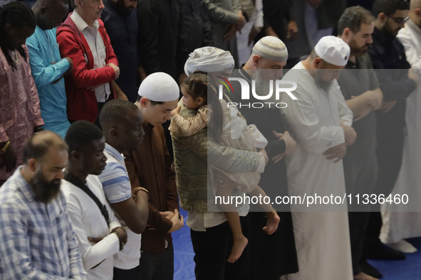 In the center, an adult is carrying a girl from the Muslim community in Mexico City, Mexico, on the occasion of the celebration of Eid al-Ad...