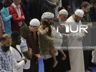 In the center, an adult is carrying a girl from the Muslim community in Mexico City, Mexico, on the occasion of the celebration of Eid al-Ad...