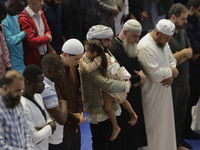 In the center, an adult is carrying a girl from the Muslim community in Mexico City, Mexico, on the occasion of the celebration of Eid al-Ad...