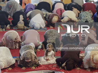 A girl from the Muslim community in Mexico City, Mexico, is praying inside the Plan Sexenal facilities on the occasion of the celebration of...