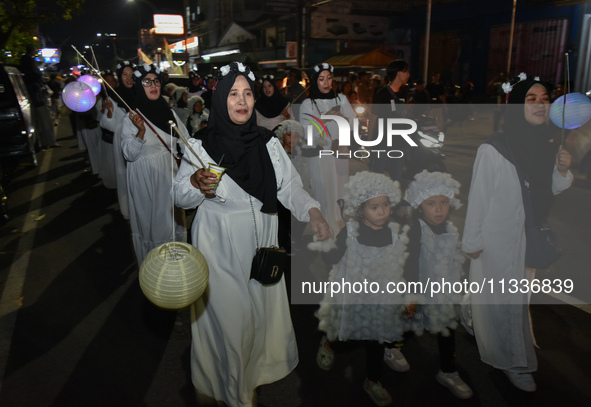 Hundreds of children are dressing as sheep during a lantern parade to celebrate Eid al-Adha on the city streets in Malang, East Java, Indone...