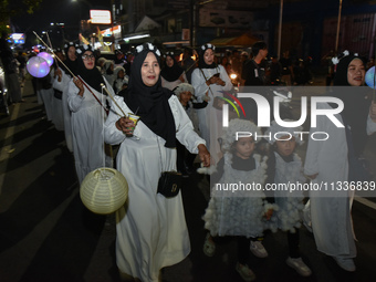 Hundreds of children are dressing as sheep during a lantern parade to celebrate Eid al-Adha on the city streets in Malang, East Java, Indone...