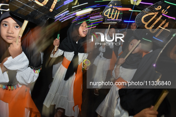 Hundreds of participants are carrying lanterns and posters as they celebrate Eid al-Adha on the city streets in Malang, East Java, Indonesia...