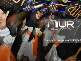 Hundreds of participants are carrying lanterns and posters as they celebrate Eid al-Adha on the city streets in Malang, East Java, Indonesia...