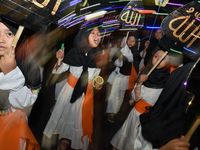 Hundreds of participants are carrying lanterns and posters as they celebrate Eid al-Adha on the city streets in Malang, East Java, Indonesia...