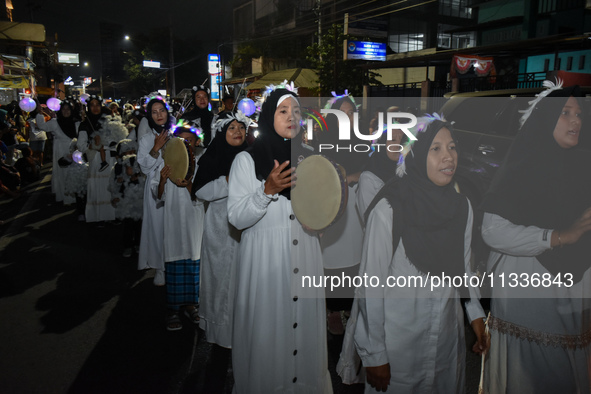 Hundreds of participants are carrying lanterns and posters as they celebrate Eid al-Adha on the city streets in Malang, East Java, Indonesia...