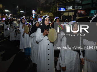 Hundreds of participants are carrying lanterns and posters as they celebrate Eid al-Adha on the city streets in Malang, East Java, Indonesia...