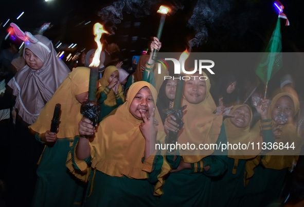 Hundreds of participants are carrying lanterns and posters as they celebrate Eid al-Adha on the city streets in Malang, East Java, Indonesia...