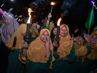 Hundreds of participants are carrying lanterns and posters as they celebrate Eid al-Adha on the city streets in Malang, East Java, Indonesia...