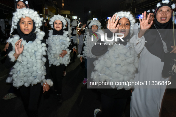 Hundreds of children are dressing as sheep during a lantern parade to celebrate Eid al-Adha on the city streets in Malang, East Java, Indone...