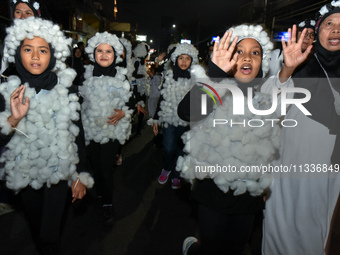 Hundreds of children are dressing as sheep during a lantern parade to celebrate Eid al-Adha on the city streets in Malang, East Java, Indone...