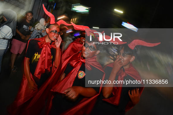 Hundreds of participants are carrying lanterns and posters as they celebrate Eid al-Adha on the city streets in Malang, East Java, Indonesia...