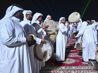 A Qatari traditional band is performing during the celebration of the first day of the Eid Al-Adha festival at Katara Cultural Village in Do...