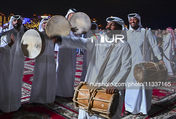 A Qatari traditional band is performing during the celebration of the first day of the Eid Al-Adha festival at Katara Cultural Village in Do...