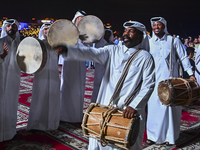 A Qatari traditional band is performing during the celebration of the first day of the Eid Al-Adha festival at Katara Cultural Village in Do...