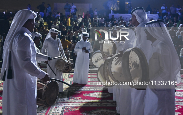 A Qatari traditional band is performing during the celebration of the first day of the Eid Al-Adha festival at Katara Cultural Village in Do...