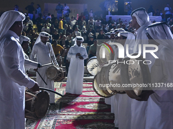 A Qatari traditional band is performing during the celebration of the first day of the Eid Al-Adha festival at Katara Cultural Village in Do...