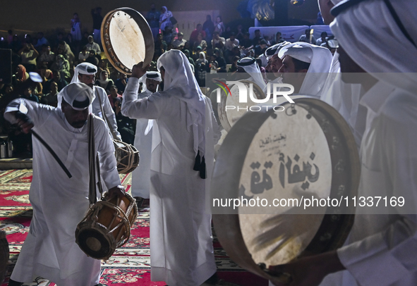 A Qatari traditional band is performing during the celebration of the first day of the Eid Al-Adha festival at Katara Cultural Village in Do...