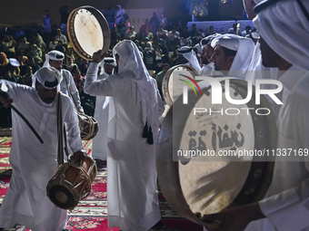 A Qatari traditional band is performing during the celebration of the first day of the Eid Al-Adha festival at Katara Cultural Village in Do...