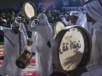 A Qatari traditional band is performing during the celebration of the first day of the Eid Al-Adha festival at Katara Cultural Village in Do...