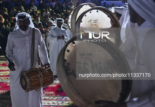 A Qatari traditional band is performing during the celebration of the first day of the Eid Al-Adha festival at Katara Cultural Village in Do...