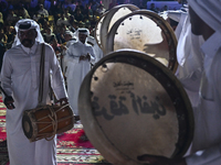 A Qatari traditional band is performing during the celebration of the first day of the Eid Al-Adha festival at Katara Cultural Village in Do...