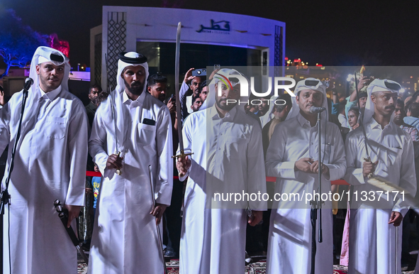 A Qatari traditional band is performing during the celebration of the first day of the Eid Al-Adha festival at Katara Cultural Village in Do...