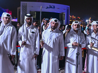 A Qatari traditional band is performing during the celebration of the first day of the Eid Al-Adha festival at Katara Cultural Village in Do...