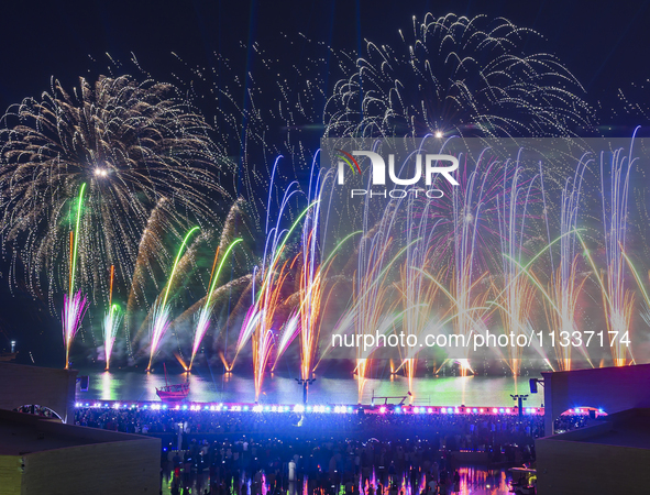 Fireworks are lighting up the sky over Katara Cultural Village during the celebration of the first day of the Eid Al-Adha festival in Doha,...