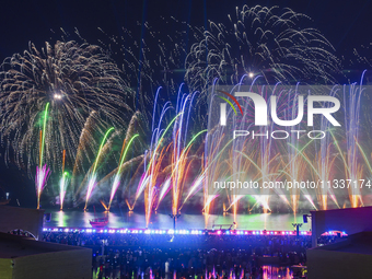 Fireworks are lighting up the sky over Katara Cultural Village during the celebration of the first day of the Eid Al-Adha festival in Doha,...