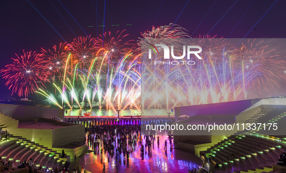 Fireworks are lighting up the sky over Katara Cultural Village during the celebration of the first day of the Eid Al-Adha festival in Doha,...