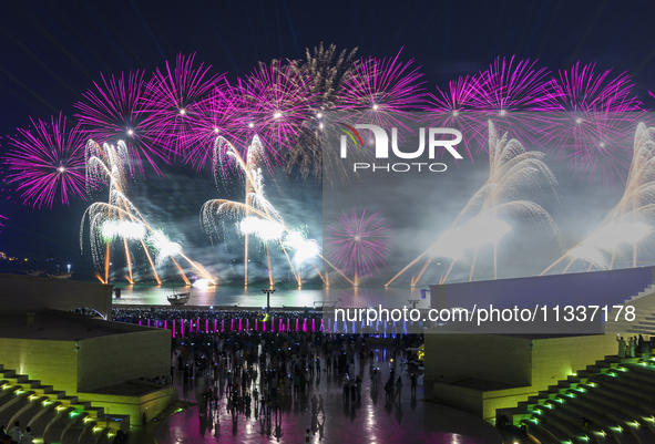 Fireworks are lighting up the sky over Katara Cultural Village during the celebration of the first day of the Eid Al-Adha festival in Doha,...