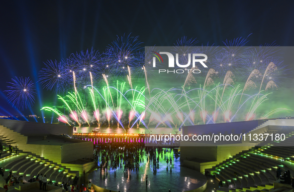 Fireworks are lighting up the sky over Katara Cultural Village during the celebration of the first day of the Eid Al-Adha festival in Doha,...