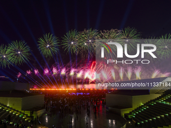 Fireworks are lighting up the sky over Katara Cultural Village during the celebration of the first day of the Eid Al-Adha festival in Doha,...