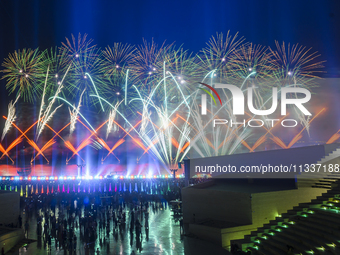 Fireworks are lighting up the sky over Katara Cultural Village during the celebration of the first day of the Eid Al-Adha festival in Doha,...