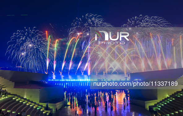 Fireworks are lighting up the sky over Katara Cultural Village during the celebration of the first day of the Eid Al-Adha festival in Doha,...