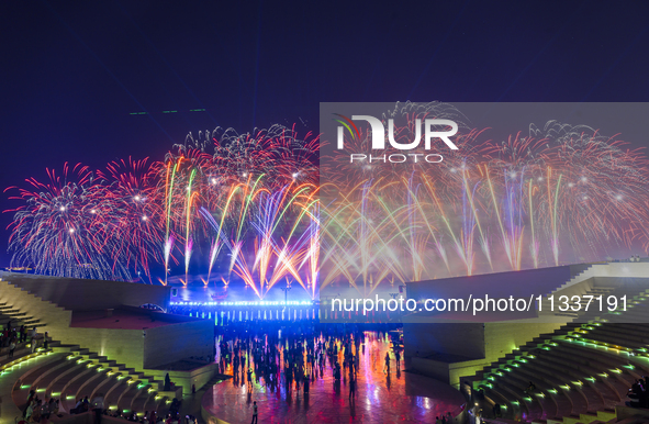 Fireworks are lighting up the sky over Katara Cultural Village during the celebration of the first day of the Eid Al-Adha festival in Doha,...