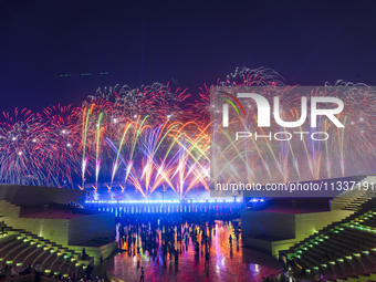 Fireworks are lighting up the sky over Katara Cultural Village during the celebration of the first day of the Eid Al-Adha festival in Doha,...