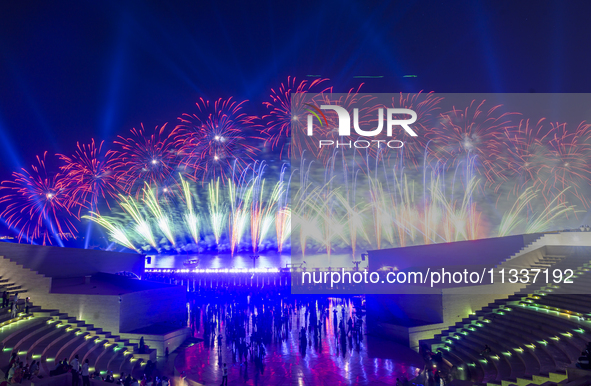 Fireworks are lighting up the sky over Katara Cultural Village during the celebration of the first day of the Eid Al-Adha festival in Doha,...