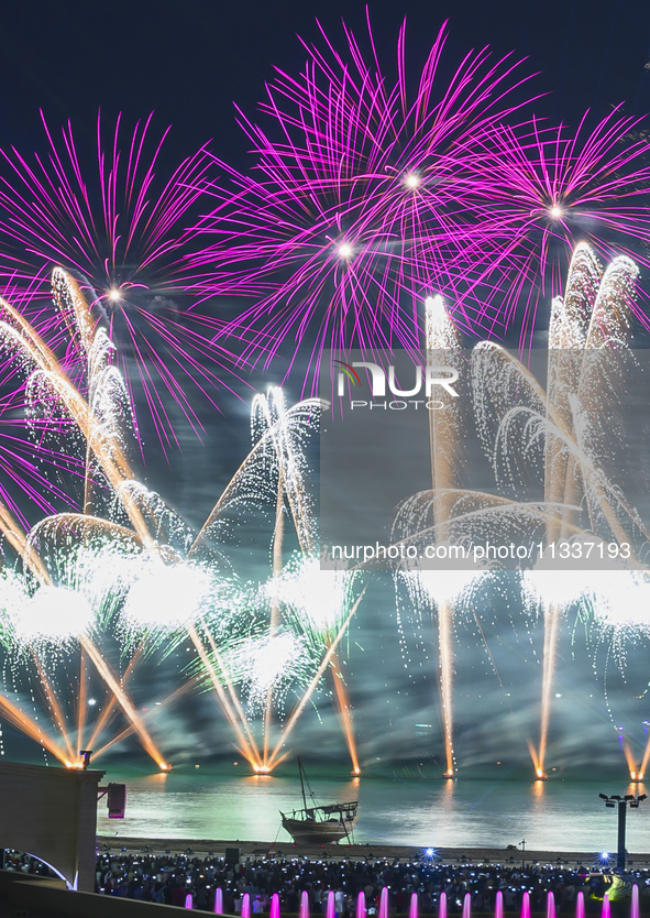 Fireworks are lighting up the sky over Katara Cultural Village during the celebration of the first day of the Eid Al-Adha festival in Doha,...