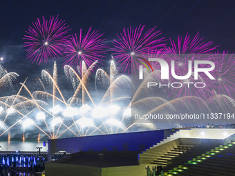 Fireworks are lighting up the sky over Katara Cultural Village during the celebration of the first day of the Eid Al-Adha festival in Doha,...