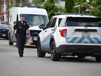 An evidence bag is being loaded into a Chicago police vehicle at the crime scene. Two people are being shot, with one person being shot mult...