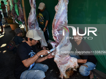 (EDITOR'S NOTE: Graphic content) Residents are working together to cut hundreds of goats to be distributed to the public during the Eid al-A...