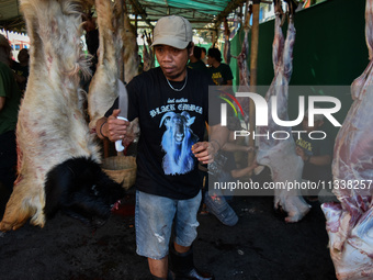 (EDITOR'S NOTE: Graphic content) Residents are working together to cut hundreds of goats to be distributed to the public during the Eid al-A...